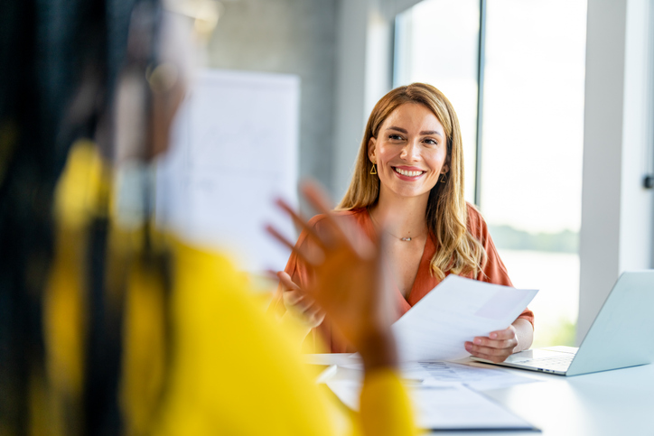 Newly hired employee in discussion with an office manager. A great candidate fit for the job—an office manager discussing tasks with a newly hired employee in a professional workspace.