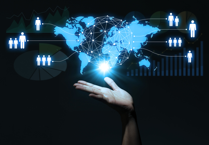 Expanding hiring horizons with global talent access. Global talent access—human hand connecting to a world map, representing an extensive talent database across industries and geographies.